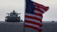 A U.S. flag flutters in the wind as the CHIOS crude oil tanker sits anchored off the coast of the Chevron's El Segundo Refinery in El Segundo, California, on March 4, 2026. 

Markets have been roiled much of the week as the conflict between the US and Iran effectively closed shipping through the Strait of Hormuz, where a fifth of the world's crude oil travels as well as considerable liquefied natural gas (LNG) supplies travel through.