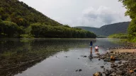Children play on the banks of the West Branch of the Susquehanna River in Pennsylvania, in September 2025. Once deemed a "dead" river due to pollution from unregulated coal mining, the West Branch has undergone a major revival through intensive reclamation and treatment projects.