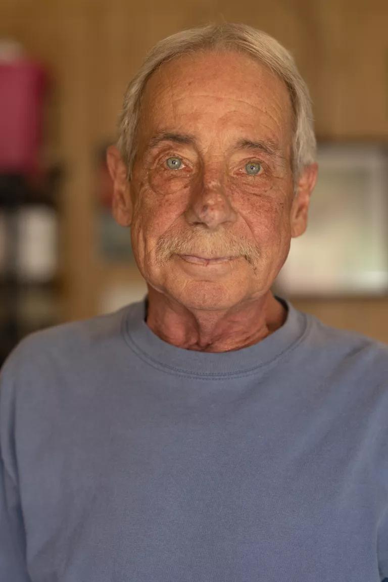 An elderly person facing the camera
