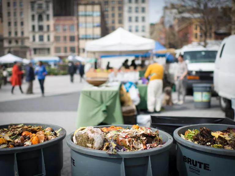 Bins to collect food scraps for compost at Union Square Greenmarket in Manhattan, New York City.