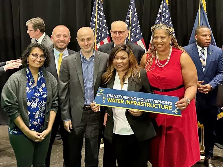 Environmental advocates and government officials stand for a photo after a press conference.