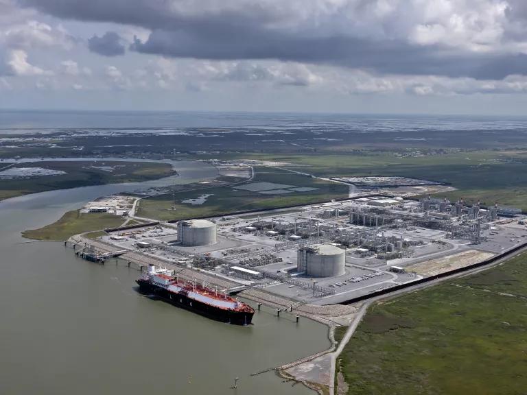 Aerial view of an LNG tanker is docked at a liquified natural gas export facility that is built on wetlands