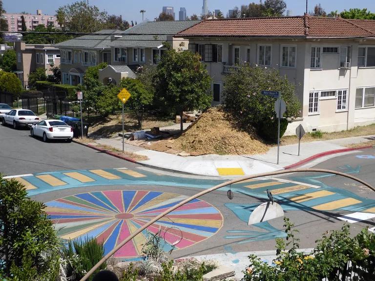 Colorful artwork painted on the street brightens an intersection within the Los Angeles Eco-Village co-op