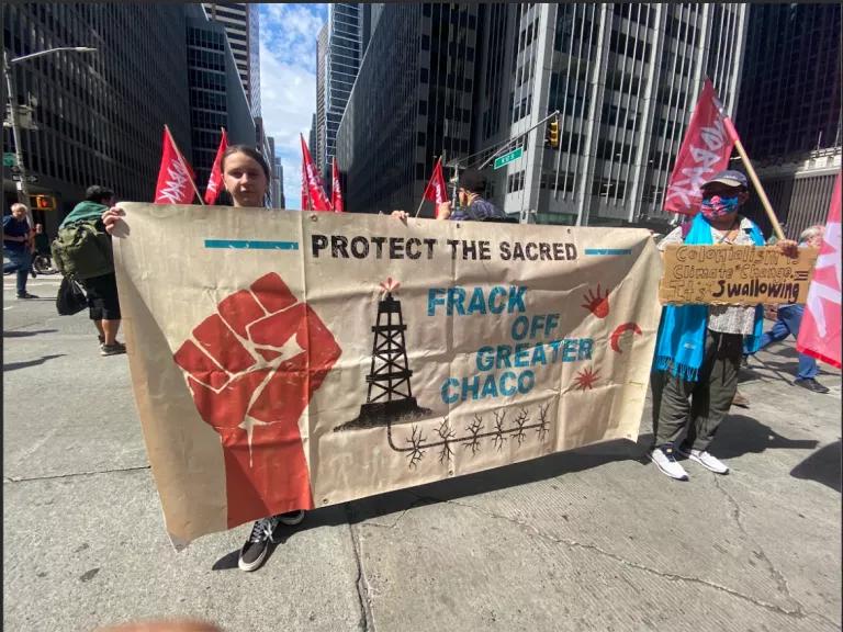 March attendees hold up banners.