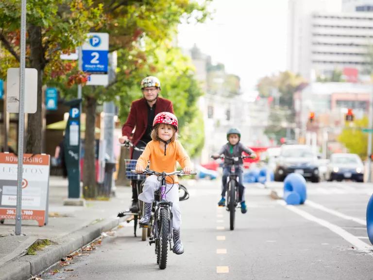 A young boy riding his bicycle in a dedicated bike lane on Broadway in Seattle, Washington.