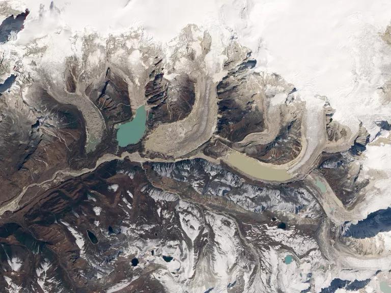 An aerial view of Bhutan’s snow-covered Table Mountain showing glaciers and their associated glacial lakes.
