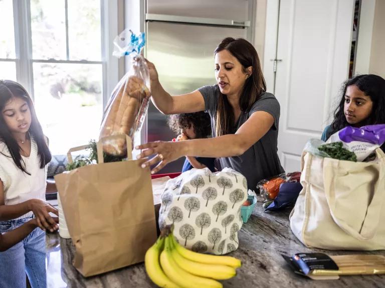 A family unpacks their groceries after a trip to the supermarket.
