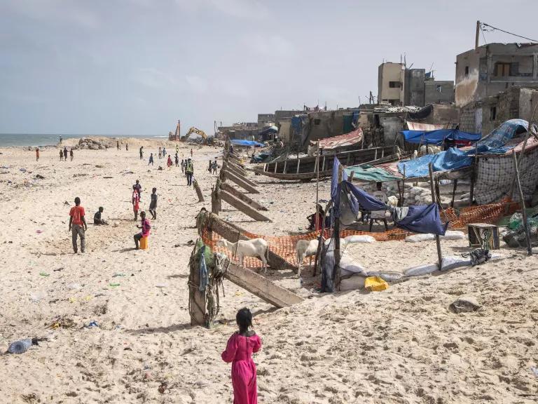People gather along the beach of the partially destroyed seaside fishing neighborhood of Guet Ndar in Saint Louis, Senegal, on August 10, 2021. 

Rising seas have displaced hundreds of people from Guet Ndar to relocation camps. The government plans to relocate fifteen thousand people who live within twenty meters of the beach.