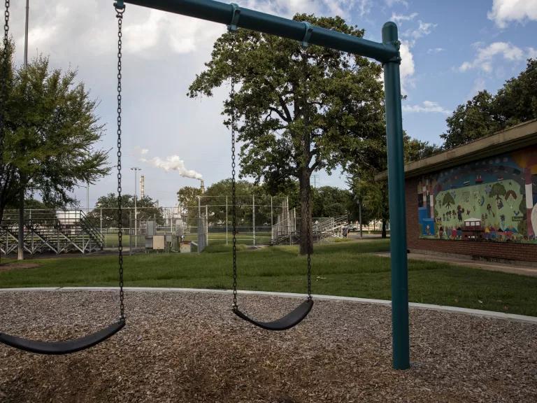 Swings in a children's playground at Hartman Park in the Harrisburg/Manchester neighborhood beside the Valero Houston Refinery located on the Houston Ship Channel in Houston, Texas.