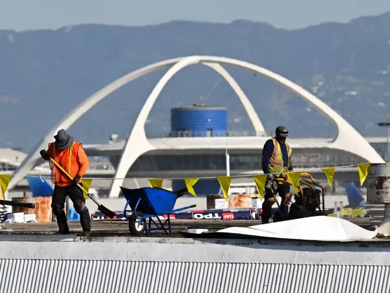 Waves of heat rise as workers repair a roof during high temperatures at the Los Angeles International Airport (LAX) in Los Angeles, California, on September 9, 2024.