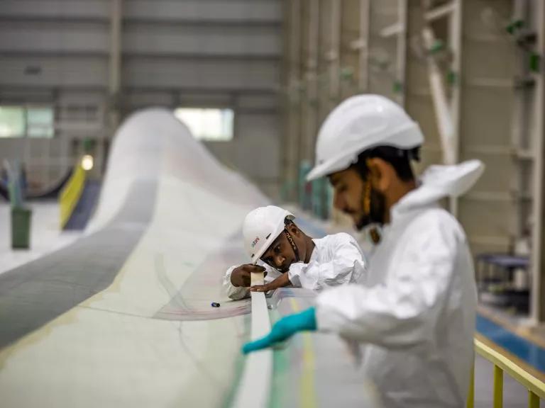 Workers inside the wind turbine blade manufacturing facility of Adani Wind, a division of Adani New Industries Ltd. (ANIL), in Mundra, Gujarat, India, on Octber 30, 2023.