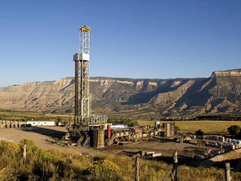 A gas drilling rig framed by the cliffs of the Roan Plateau in Rulison, Colorado. New wells will add to some 7,500 operating wells in the energy rich Roan Plateau region where an estimated 50,000 wells may be drilled over next 30 years.
