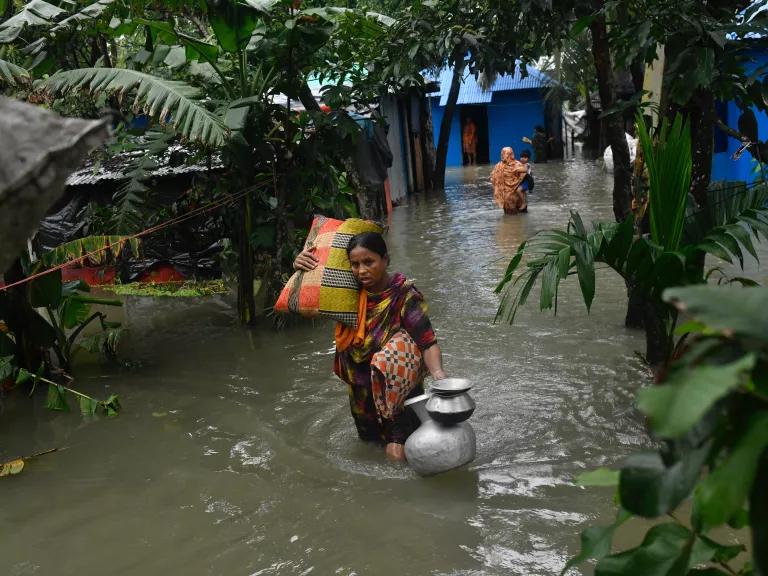 Local residents shift to temporary shelter as floodwater rises in their homes in Feni, Chittagong, Bangladesh, on August 23, 2024.
