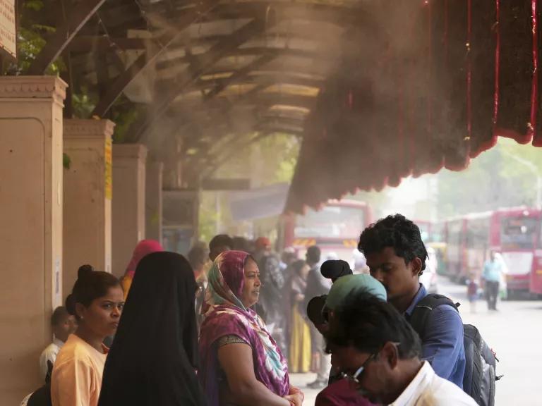 People waiting at a cool bus stop in Ahmedabad, India, on April 2, 2025.

An early heatwave saw temperatures climb to 108°F.