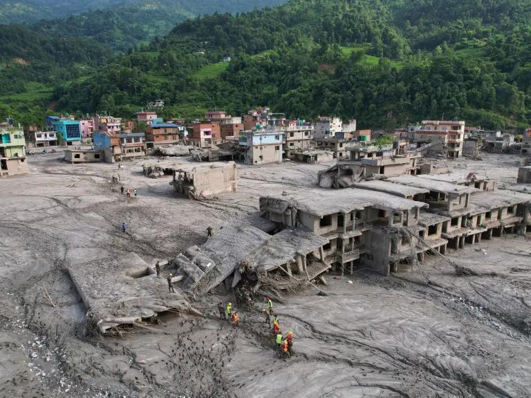 Rescue workers search damaged structures following flash flooding along the Trishuli River in Nuwakot District, Nepal, on August 29, 2026.