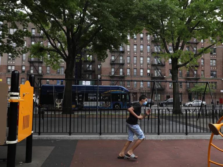 A teenager runs through a neighborhood playground in the South Bronx, New York City.