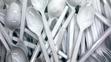 A pile of plastic spoons