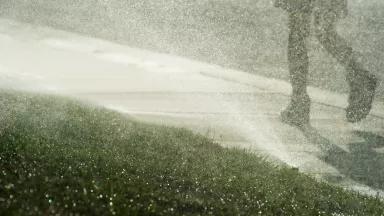 A sprinkler watering grass in Bakersfield, California