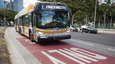 A bus labelled "1 Kahala Mall" drives in the bus-only lane
