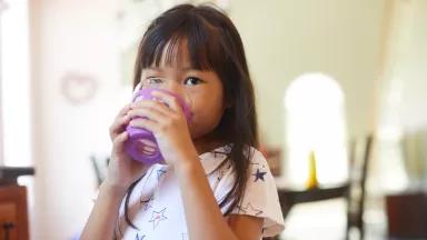 A child drinking a glass of water