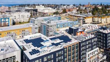 Rooftop solar panels on apartment buildings in West Seattle, Washington.