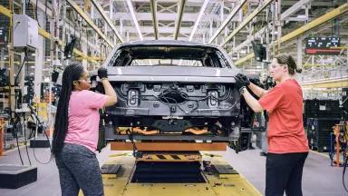 Workers on the 2022 Ford F-150 Lightning Pro electric pickup truck production line at the Electric Vehicle Center on the grounds of the Ford River Rouge complex in Dearborn, Michigan.