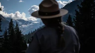 A Park Ranger talks to visitors at Jackson Glacier Overlook in Glacier National Park, Montana.