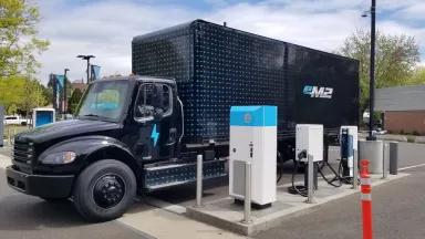 An electric semi-trailer truck parked at "Electric Island", a charging site designed for heavy-duty trucks in Portland, Oregon.