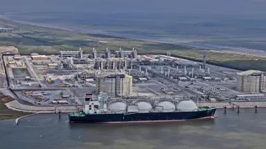 An aerial view of a liquefied natural gas (LNG) tanker ship docked at Venture Global’s Calcasieu Pass export facility in Cameron Parish, Louisiana.
