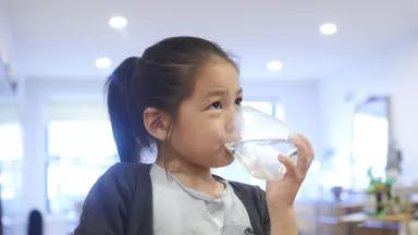 Sota, 6, drinking a glass of water in the kitchen at his home in Brooklyn, New York City.
