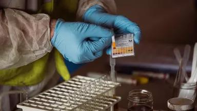 A chemist from the Environmental Protection Agency (EPA) carries out tests to identify and categorize different household hazardous wastes in Salinas, Puerto Rico, on January 10, 2018.