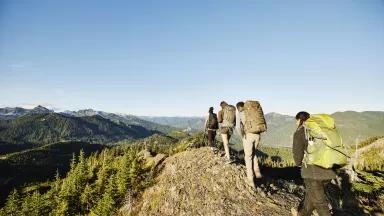 A group of people hiking along a mountain ridge in Washington.