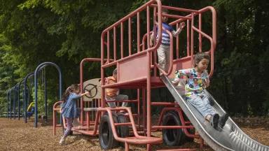 Children playing on a playground in a public park.