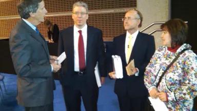 NRDC's Joel Reynolds and Nunamta Aulukestai's Kimberley Williams with Rio Tinto CEO Tom Albanese and Board Chairman Jan du Plessis (holding the petitions), following the Rio Tinto shareholder meeting. 