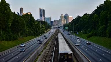 A MARTA train travels along the Georgia State Route 400 highway towards the Buckhead neighborhood of Atlanta, Georgia.