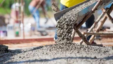 Wet cement being poured onto the ground