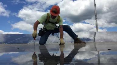 An IBEW member installs a solar panel
