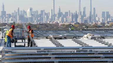 Electricians with IBEW Local 3 installing solar panels at LaGuardia Airport in Queens, New York City.