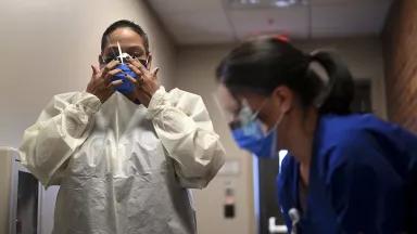 Two health workers wearing masks
