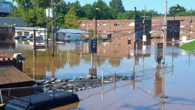 Flooded streets around an auto repair shop and apartment buildings