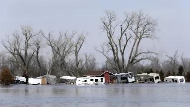 Multiple mobile homes and RVs are moved and damaged by flood waters