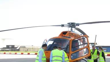 Researchers explaining how chemical sensors (attached to the front of the helicopter) are used to measure air pollutants from ships as the helicopter flies into ship exhaust plumes near the Port of Rotterdam 