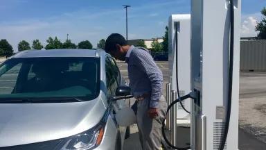 Madhur plugging in our Bolt at a Level 3 charger