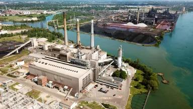 An aerial view of a coal-powered plant surrounded by waterways and industry