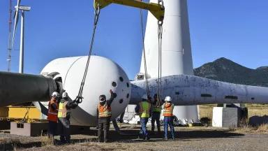 Crew works on a wind turbine in CO